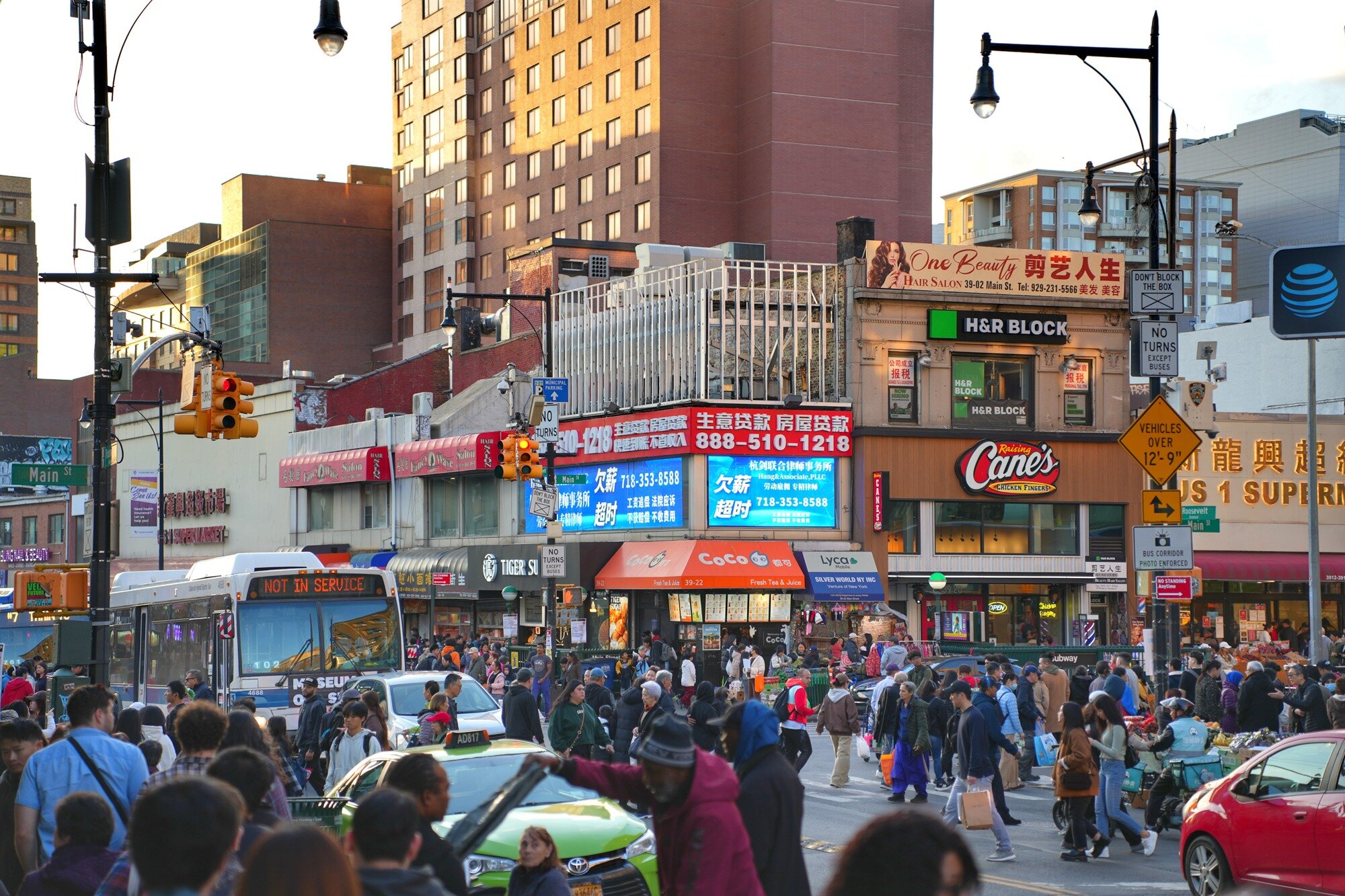 Buses, private cars, shoppers, visitors, and residents move through downtown Flushing. Nov. 8, 2025.