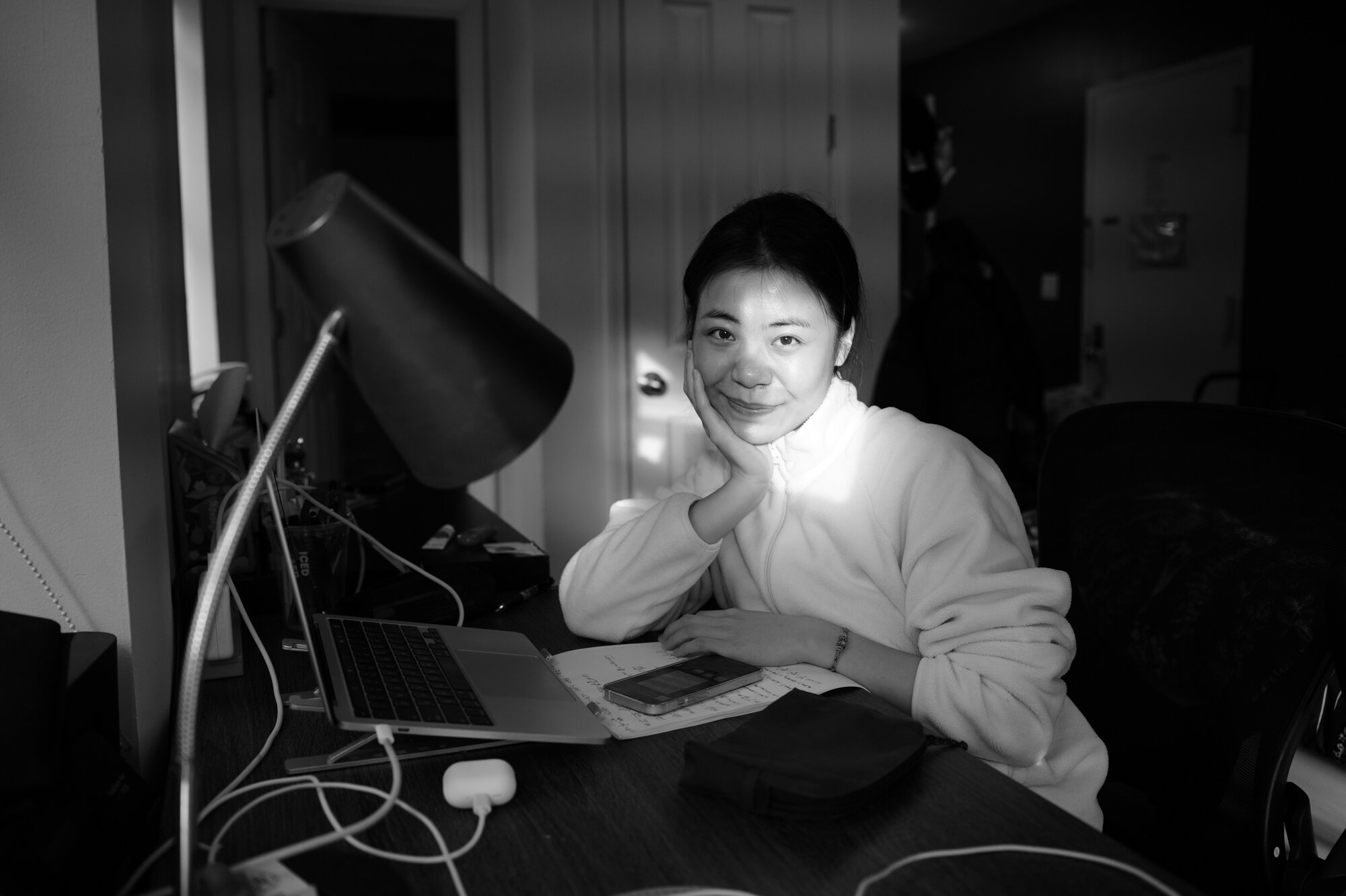 Christine Cheng, 23, rests at her desk after completing algebra homework. New York, Nov. 19, 2025.